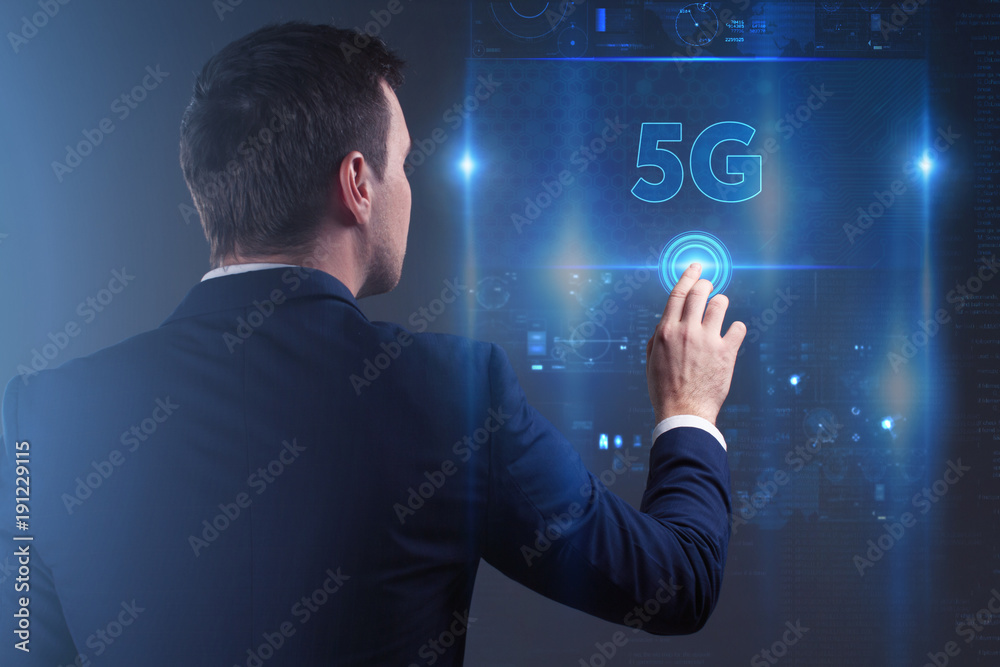 Business, Technology, Internet and network concept. Young businessman working on a virtual screen of the future and sees the inscription: 5G Business, Technology, Internet and network concept. Young businessman working on a virtual screen of the future and sees the inscription: 5G