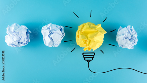 Creative idea, Inspiration, New idea and Innovation concept with Crumpled Paper light bulb on blue background.