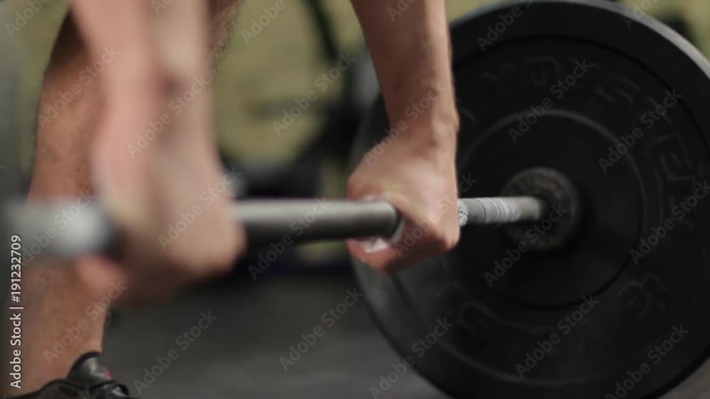 strong man's hands lifts the bar in the deadlift strong man's hands lifts the bar in the deadlift