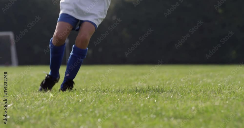 Kids training with a soccer ball on a field. Shot in slow motion on RED Epic. Kids training with a soccer ball on a field. Shot in slow motion on RED Epic.