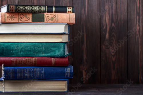 Old books on wooden background. The source of information. Books indoor. Home library. Knowledge is power