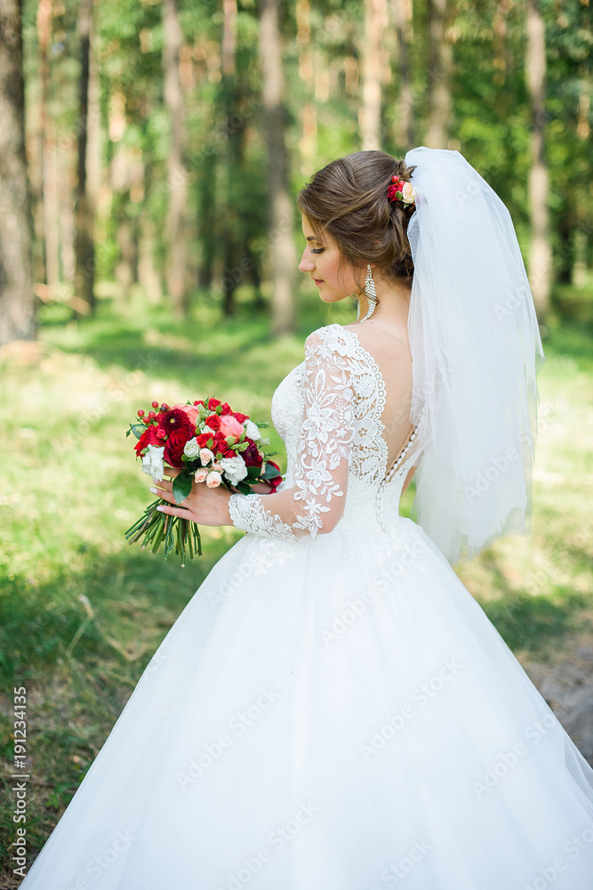 wedding dress, wedding rings, wedding bouquet. Beautiful bride outdoors
