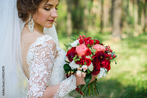 wedding dress, wedding rings, wedding bouquet. Beautiful bride outdoors