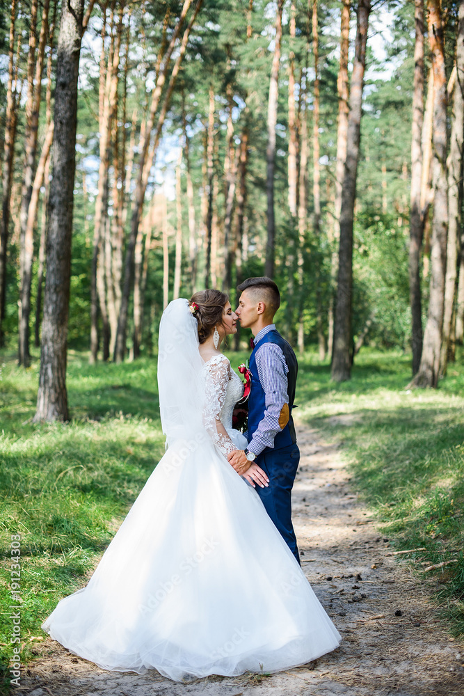 the first kiss of beautiful wedding bride and groom after the wedding ceremony. The wedding day is the day of creating a new family