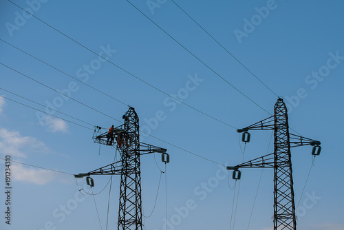 men at workinh in a electric tower photo