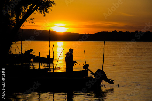 Novi Sad, Serbia May 10, 2014: Sunset on the Danube River and fisherman