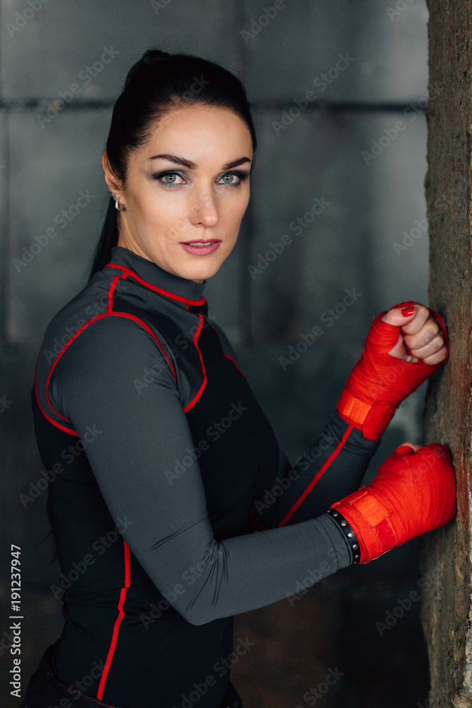 Close up portrait of a young  sportswoman. Pretty female brunete boxer. Healthy lifestyle concept. Cute  girl fighter resting after workout. Woman's day
