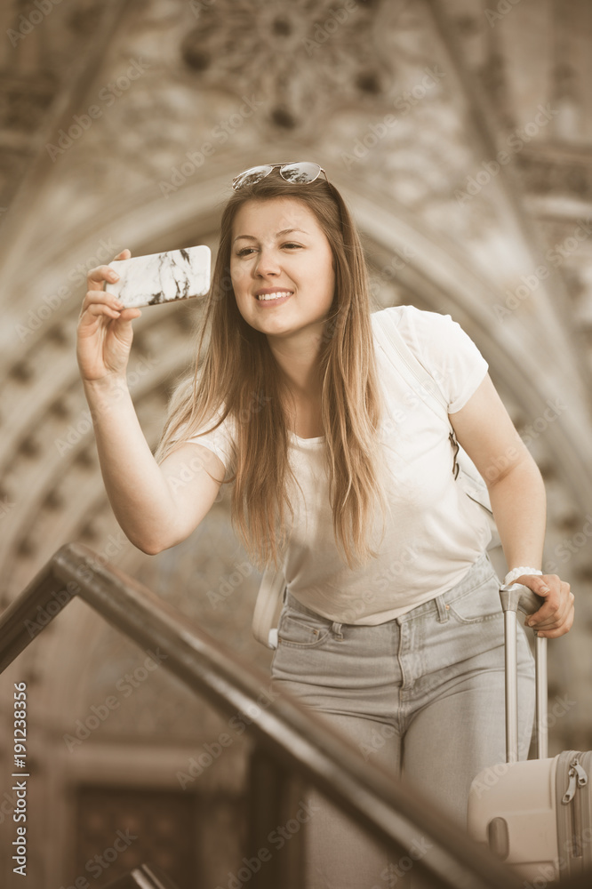 Girl holding phone and photographing