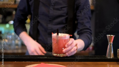 Expert barman is making cocktail at bar photo