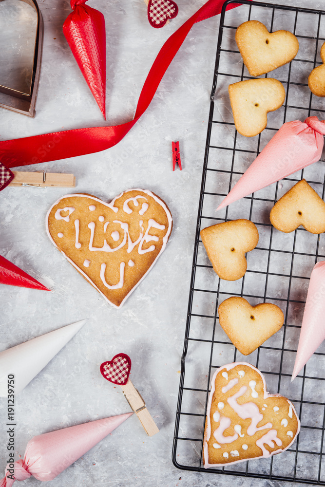 Baking Heart Shaped Cookies
for valentine's day, with colored piping bag ranging from white, pink , and red and a cookie with Baking Heart Shaped Cookies
for valentine's day, with colored piping bag ranging from white, pink , and red and a cookie with