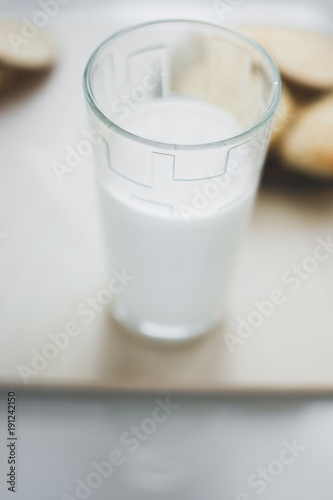 miscellaneous cookies, next to milk on a soft light background