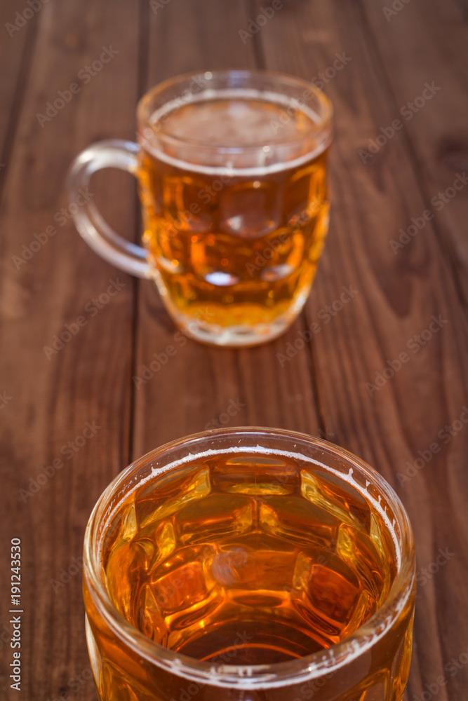Beer mugs on wooden bar benches. Beer mugs on wooden bar benches.