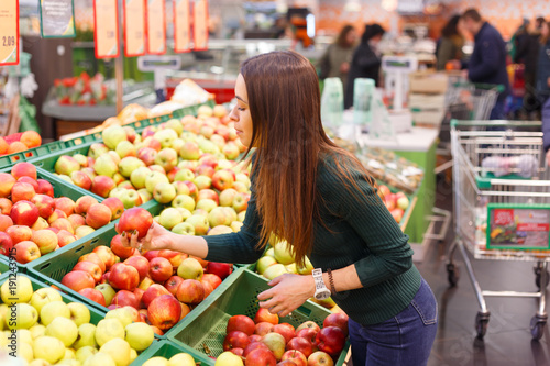 Woman buy seasonal fruits in farm food store