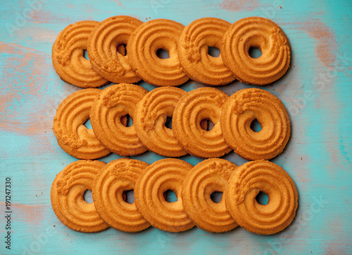 Stack of butter cookies/biscuits on wooden teal green rustic background, flat lay design with butter cookies photo