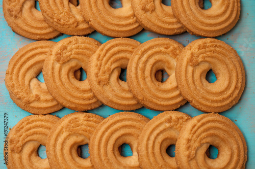 Stack of butter cookies/biscuits on wooden teal green rustic background, flat lay design with butter cookies photo