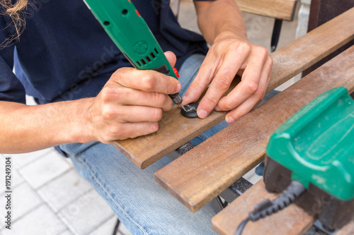 Slika na platnu Artist engraver using an electric tool for stone engraving ornaments