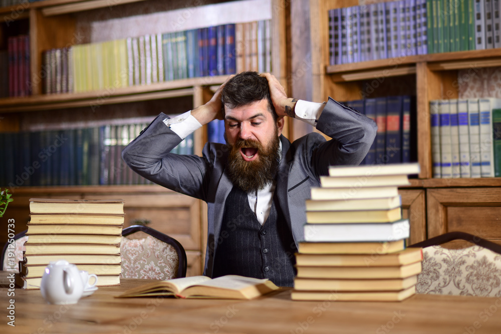 Man in classic suit or professor with mad face sits Man in classic suit or professor with mad face sits