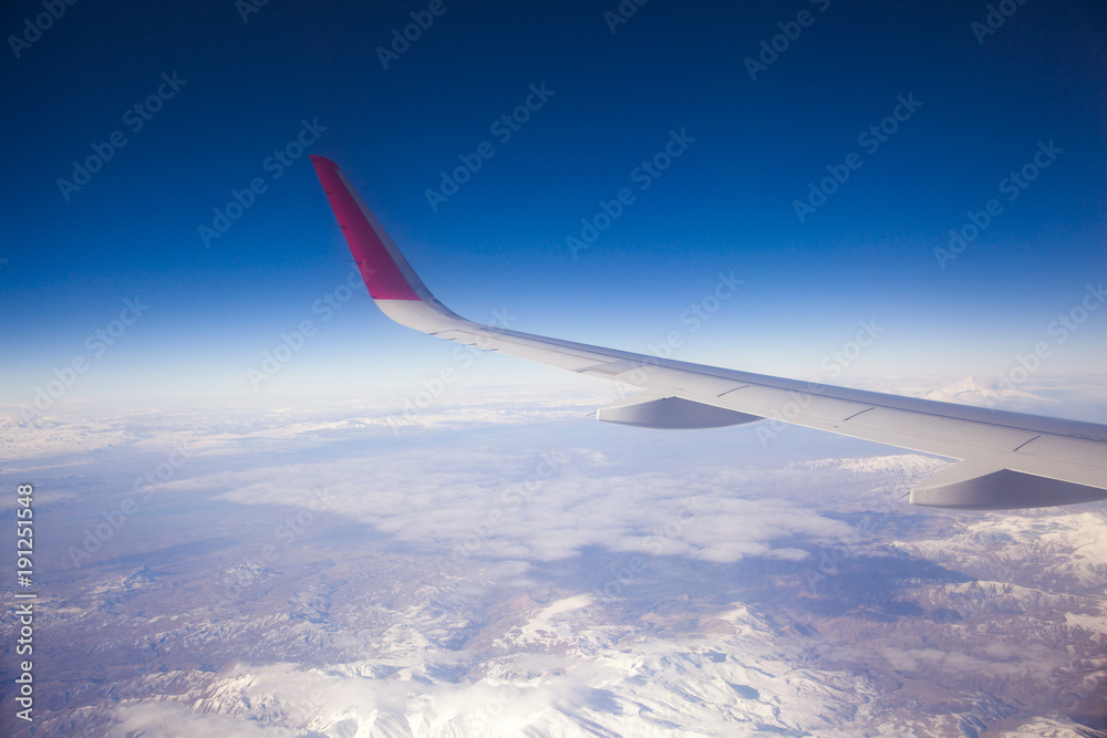 Fototapeta premium Wing aircraft in altitude during flight