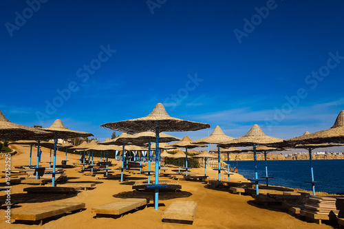 Straw umbrellas on beautiful sunny beach