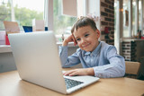 Boy focused on laptop