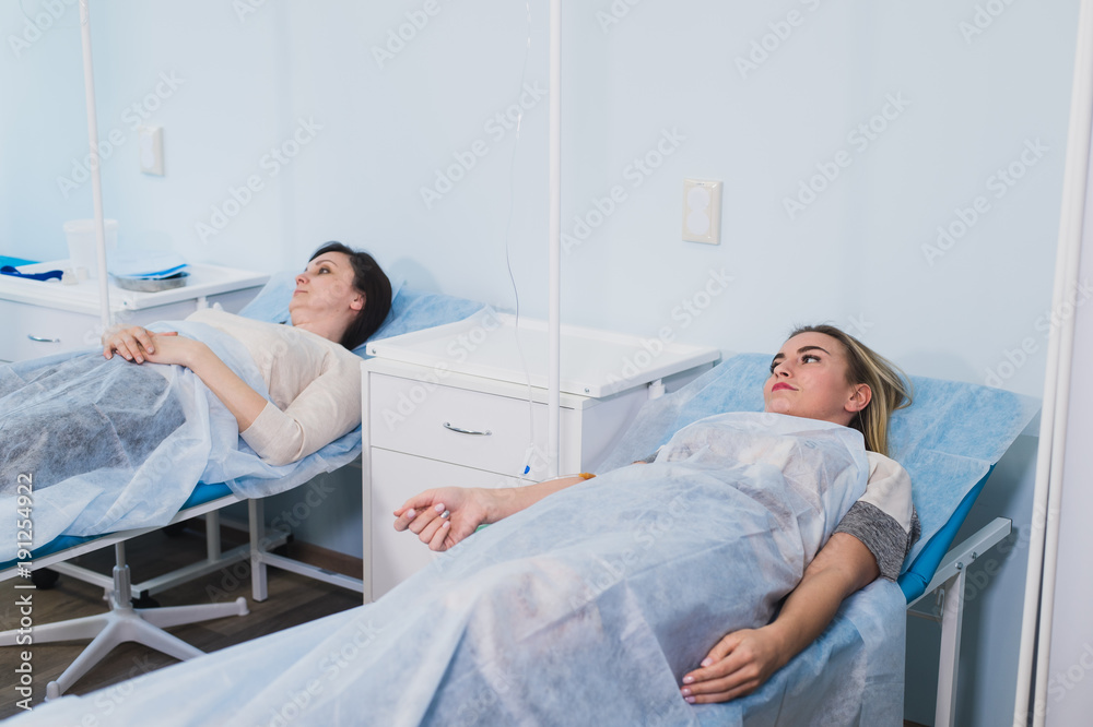 Obraz premium Female patient resting in medical bed at the hospital ward