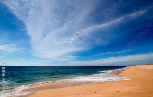 Beach under cirrus clouds at the Todos Santos artist community in central Baja California Mexico BCS