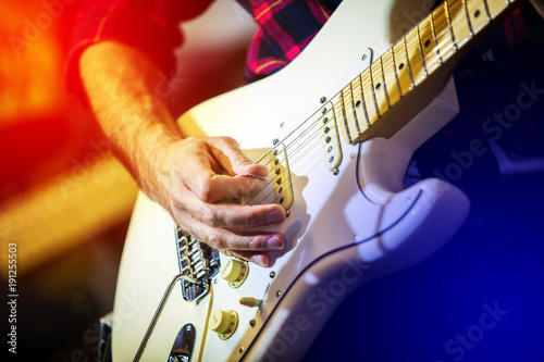 Artist playing electric guitar on the stage