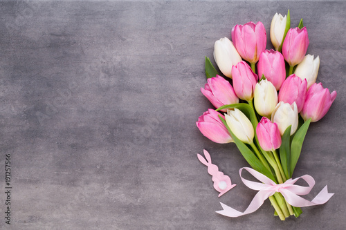 Mother's Day, woman's day, easter, pink tulips, presents on gray background.