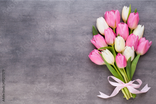 Mother's Day, woman's day, easter, pink tulips, presents on gray background.