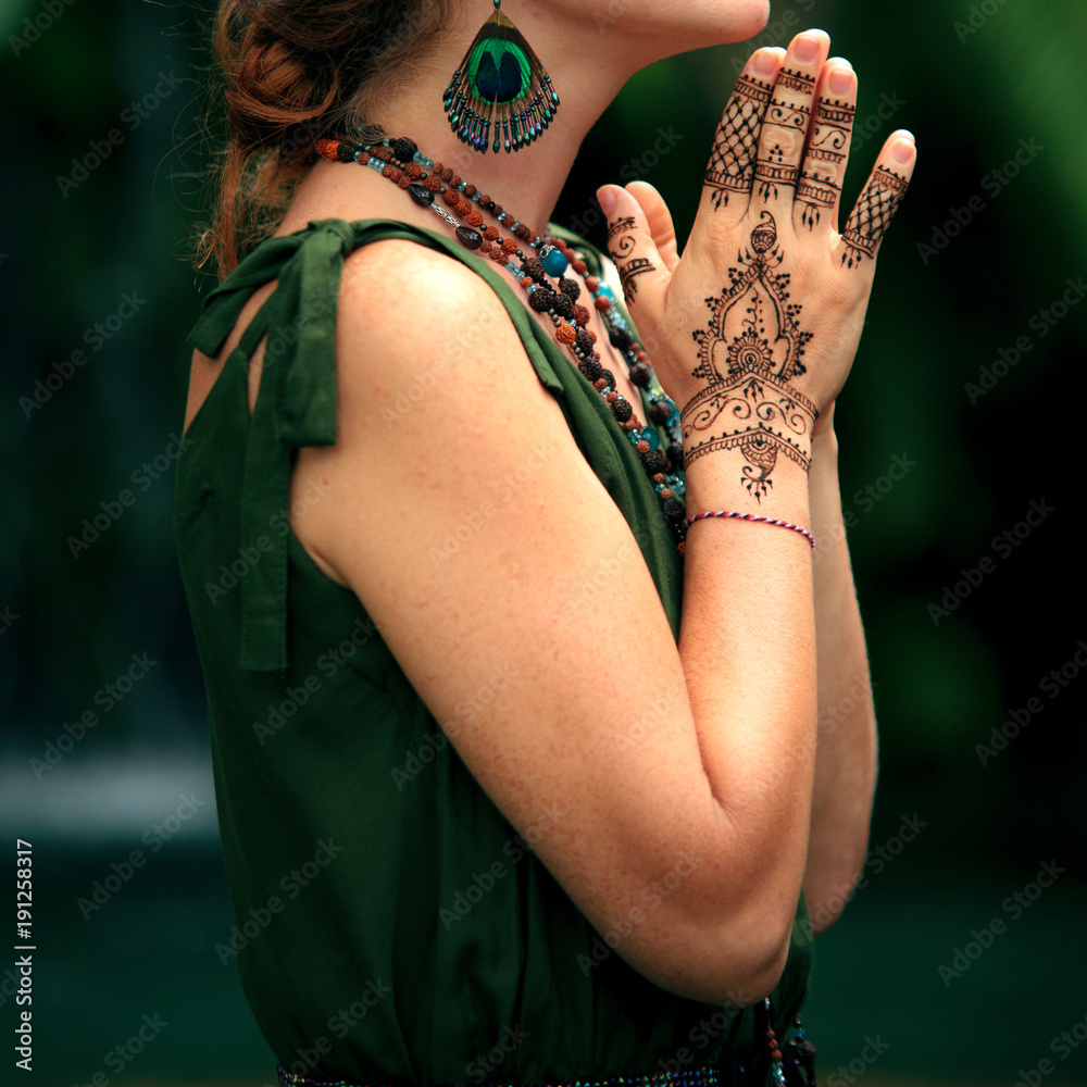 Female hands with henna tattoo praying. Beautiful indian mehendi ornaments  painted on a body part. Stock Photo | Adobe Stock