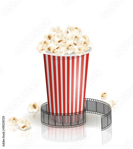 Filmstrip rolled around the full white-and-red striped bucket of popcorn. Vector illustration. Object isolated on the white background. Popcorn fallen from a bucket. Cinema snack and movie food.