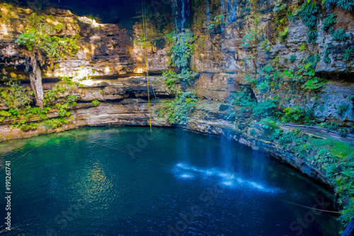 Ik-Kil Cenote near Chichen Itza, Mexico. Lovely cenote with transparent turquoise waters and hanging roots photo