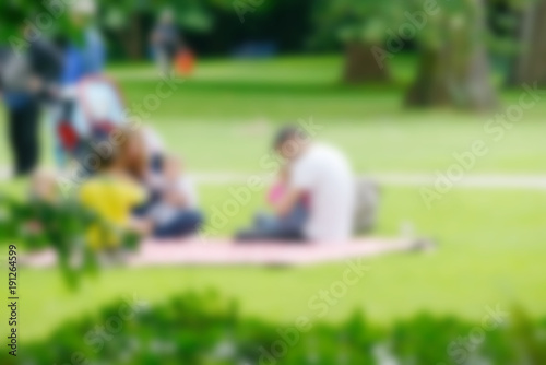 Blurred image of young family with children