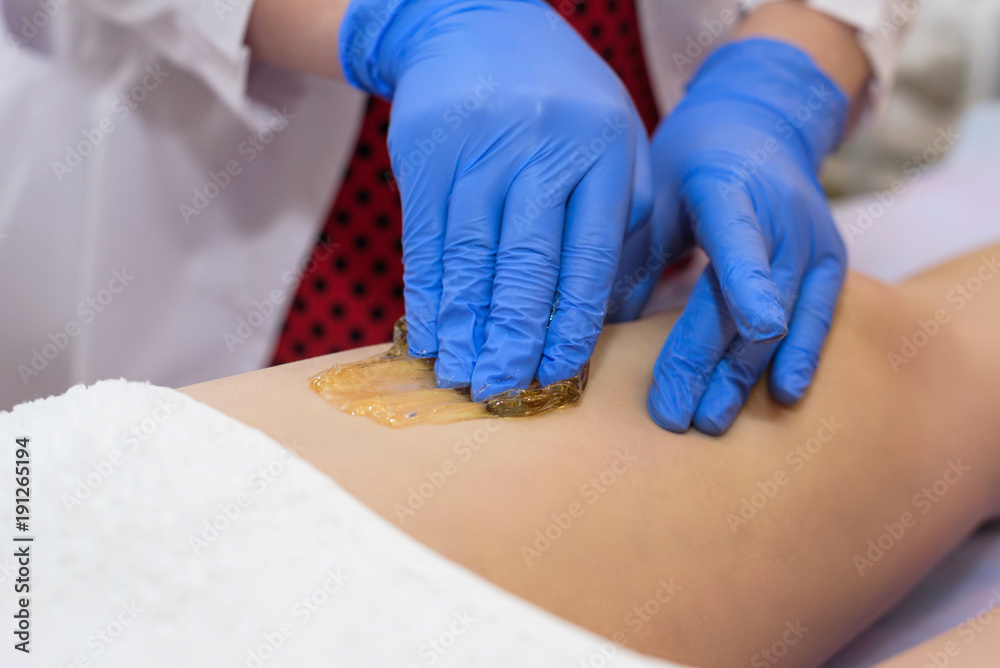 procedure of shaping on the legs in the beauty salon of the body part procedure of shaping on the legs in the beauty salon of the body part