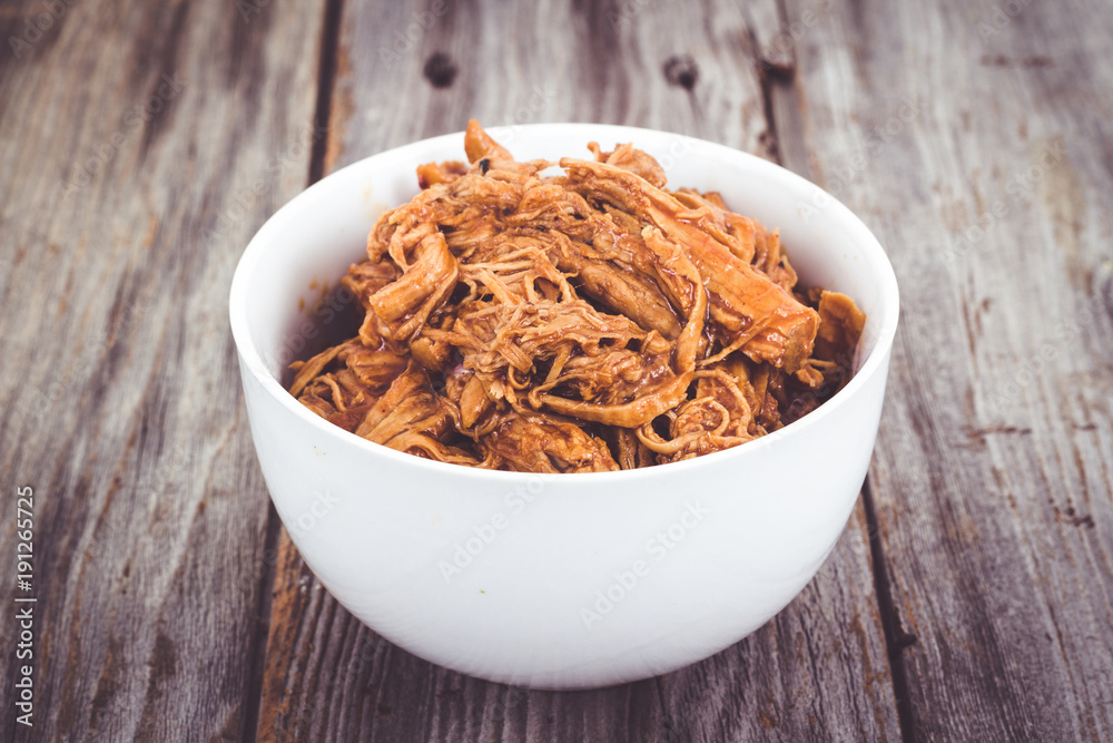 bbq pulled pork bowl over a wooden plank table bbq pulled pork bowl over a wooden plank table