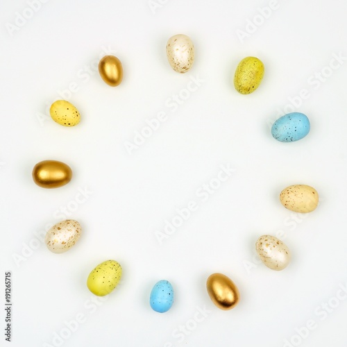 Circle of Easter Eggs over a white background. Simple, modern minimalist concept. Copy space.