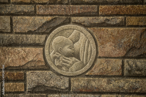 Brick wall with relief mother can child