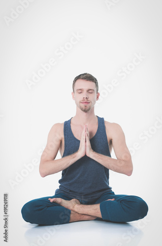 Adult man with naked torso doing exercise on white background