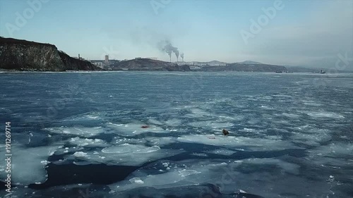 Lighthouse at Cape Basargin, Golden Horn Bay, Vladivostok symbol. Russky island. Sea of Japan. photo