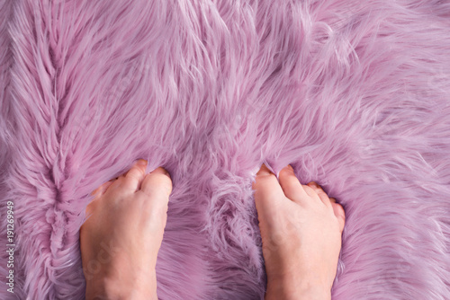 squishing toes into a soft fur rug