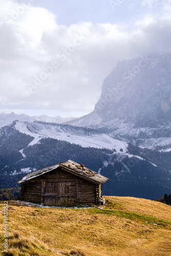 Wooden cottage in dolomities alps Italy