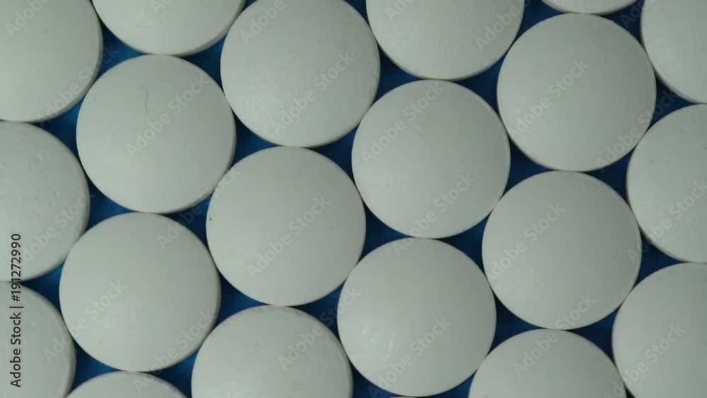 Close up white pills rotating Close up white pills rotating