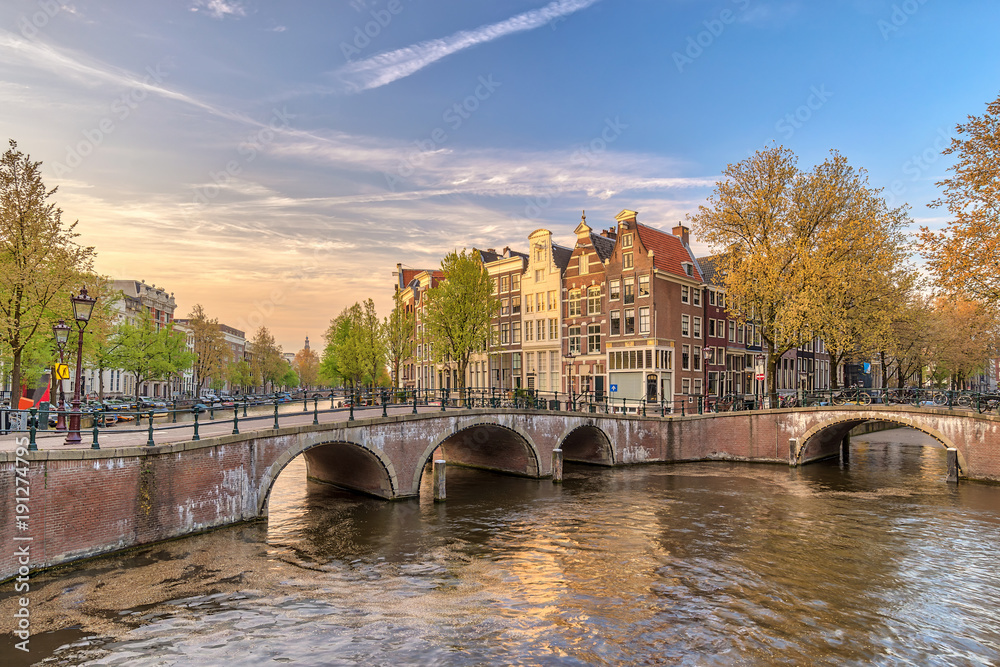 Naklejka premium Amsterdam sunset city skyline at canal waterfront, Amsterdam, Netherlands