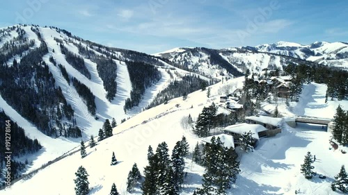 Aerial rotating shot of people skiing at deer valley