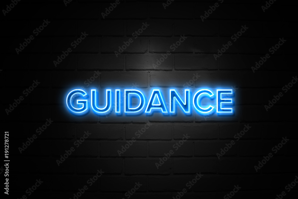 Guidance neon Sign on brickwall