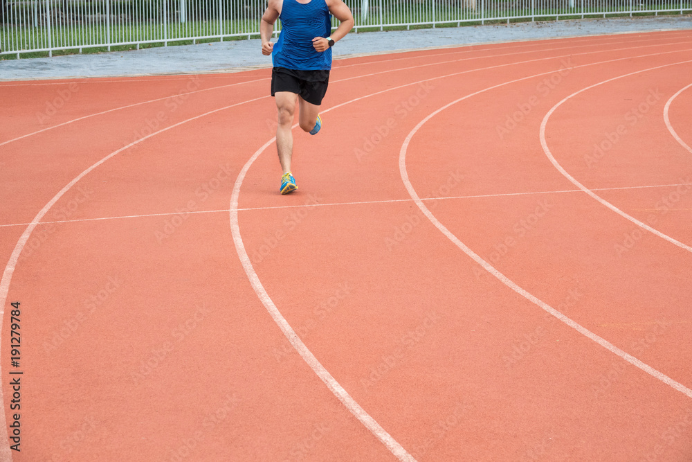 Sport man running on the race track