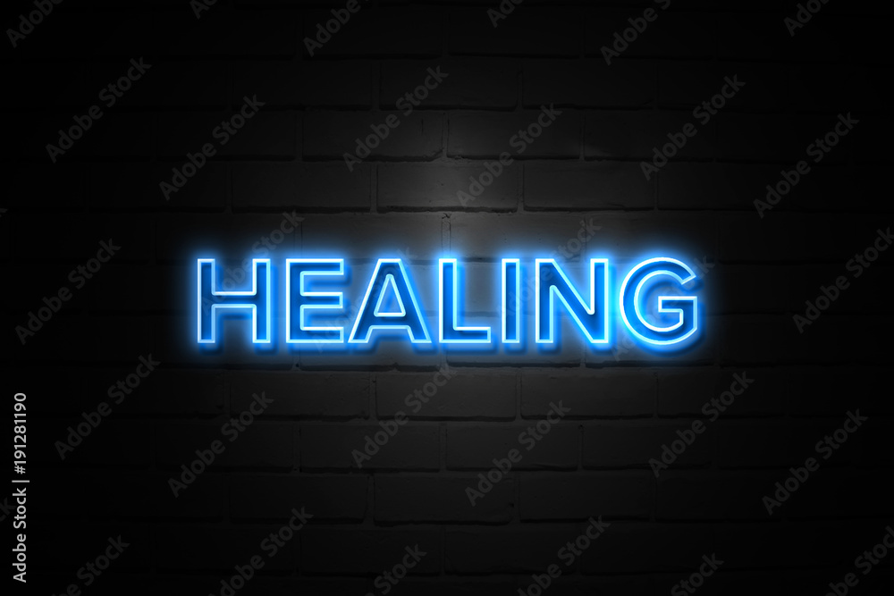Healing neon Sign on brickwall