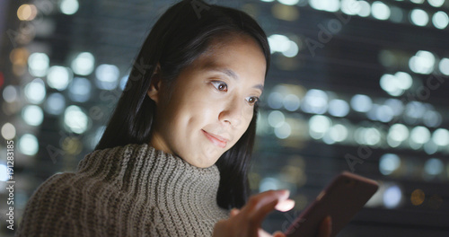 Photography Business Woman sending sms on cellphone at night