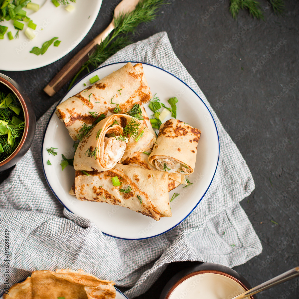 Pancakes with meat, herbs and sour cream - traditional for Russian pancake week Maslenitsa - spring festival. Happy Shrove Tuesday Pancakes with meat, herbs and sour cream - traditional for Russian pancake week Maslenitsa - spring festival. Happy Shrove Tuesday
