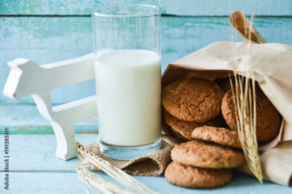 fresh oatmeal cookies with milk on wooden background fresh oatmeal cookies with milk on wooden background